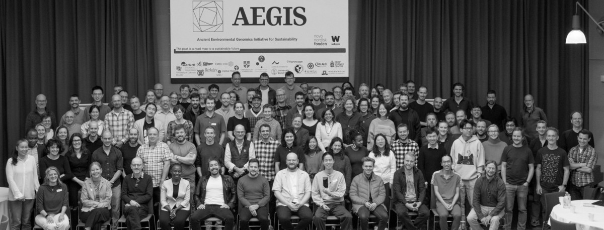 Attendees standing together with the AEGIS logo in the background at the annual AEGIS workshop 2025.