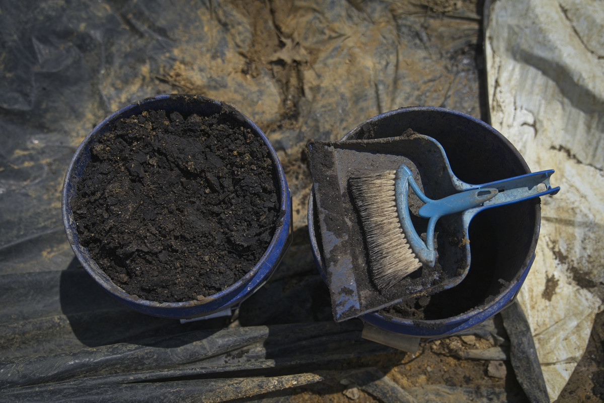 Two buckets containing soil.